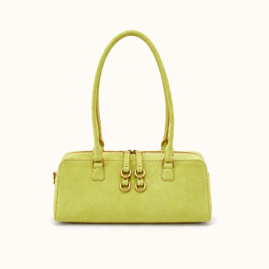 A light yellow-green leather handbag with double top handles and gold-tone hardware, shown against a plain white background.